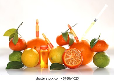 ampoules and Serum with Vitamin C. Organic cosmetics concept. Lemon, lime, orange, tangerine and cosmetic ampoules on a light background