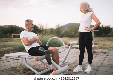 Amputee athlete exercising with friend in outdoor gym - Powered by Shutterstock