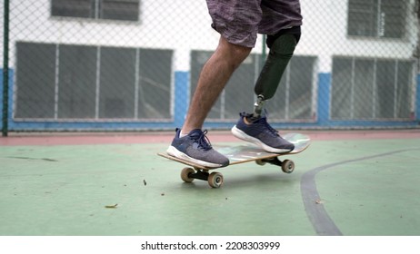 Amputee skateboarder riding skateboard with prosthetic leg - Powered by Shutterstock