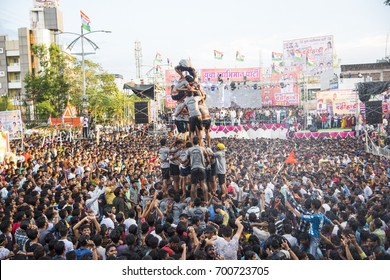 AMRAVATI, MAHARASHTRA, INDIA - 15 AUGUST 2017 : Crowd of young People "Govinda" building human tower and enjoying the Dahi Handi festival to celebrate God Krishna's Birth, in Maharashtra, India.