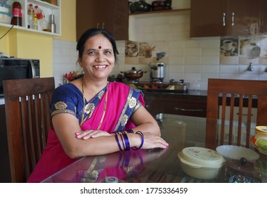 AMRAVATI, MAHARASHTRA, INDIA 7 JUNE 2020 : Unidentified happy Portrait of smiling Indian woman wearing saree in her kitchen.