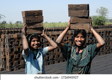 Amreli, Gujarat, India- Asia; Feb. 09, 2008 - Cncept, Child Labour Indian Rural Young Girls Working In A Brick Factory Smiley Face