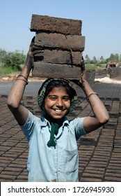 Amreli, Gujarat, India- Asia; Feb. 09, 2008 - Cncept, Child Labour Indian Rural Young Girl Working In A Brick Factory Smiley Face