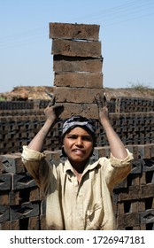 Amreli, Gujarat, India- Asia; Feb. 09, 2008 - Cncept, Child Labour Indian Rural Young Boy Working In A Brick Factory Smiley Face