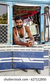 Amritsar, India, September 5, 2010: Young Indian Man, Truck Driver, Sitting And Smiling In His Truck. India.