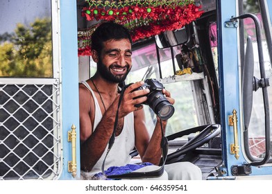 Amritsar, India, September 5, 2010: Indian Truck Driver Watching A Picture On A Camera.