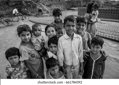 AMRITSAR, PUNJAB, INDIA - 21 APRIL 2017 : monochrome picture of Indian kids holding their younger siblings