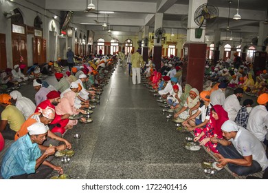 Amritsar, Punjab/ India- March 03 2020: View Of Sikh Devotees Serve Food Among The All Types Of Religious People Without Discrimination Caller Langar In Local Language 