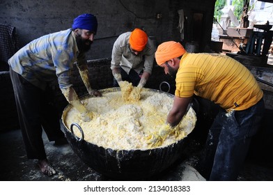 Amritsar, Punjab, India-Sep 13 2009: Volunteer Cooks Mixing Water In Lentil Flour. The Langar At The Golden Temple Has Been Serving Meals Since 1577, Harmandir Sahib, Amritsar, India.