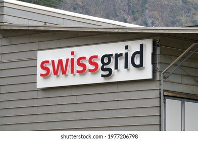 Amsteg, Uri, Switzerland - 18th April 2021 : View Of The Swissgrid Company Sign Hanging On A Building In Amsteg. Swissgrid Is The Swiss Grid Transmission System Operator