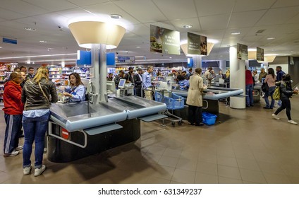 Amsterdam, April 2017. People Queuing At The Checkout Counter Of A Supermarket To Pay Their Groceries