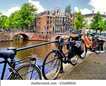 Amsterdam canal scene with bicycles and bridges