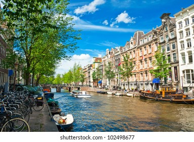 Amsterdam Canals And Typical Houses With Clear Summer Sky