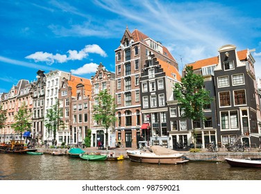 Amsterdam Canals And Typical Houses With Clear Summer Sky