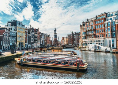 Amsterdam city in spring. Empty city in quarantine due to outbreak of infection of Coronavirus Covid-19. Famous Dutch channels and great cityscape, Netherlands, Europe.