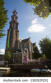 Amsterdam, Holland - August 5 2018 : View Of The Westerkerk Church Displaying A Huge Rainbow Lgbt Flag On The Tower During The Amsterdam Pride Canal Parade