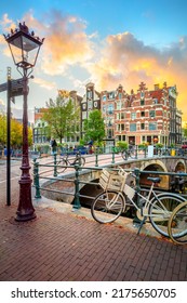 Amsterdam. Holland. Downtown of Amsterdam. Traditional houses and bridges of Amsterdam. A colorful sundown time.  Virtical
