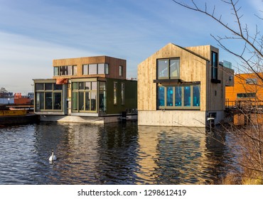 Amsterdam, January 2019. Two Floating Wooden Houses With Concrete Base. Their Construction Is Sustainable With Solar Panels, Sun Boilers And Warm Water Pumps