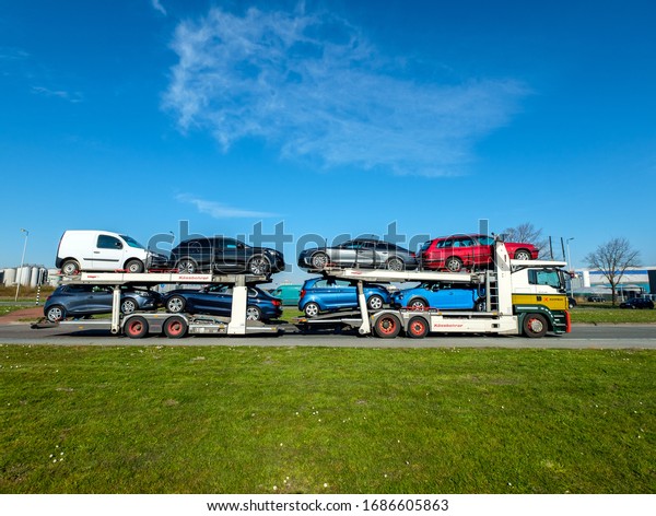 Amsterdam, March 2020. Car carrier truck loaded with\
eight cars, seen from the\
side