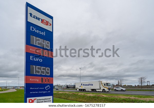 Amsterdam, Netherlands, 03-17-2020.\
\
A sing of the\
Tango gas station next to the freeway. Whit a cloudy sky and cars\
driving by. 