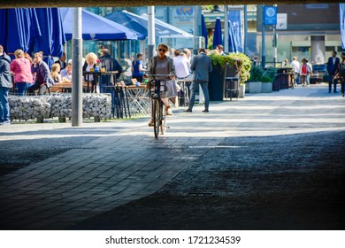 Amsterdam, The Netherlands - 06 20 2020: Woman On Bicycle Enters A Tunnel At The Nearby World Trade Center In Amsterdam