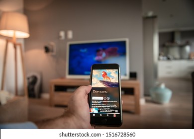 Amsterdam, The Netherlands, 09/28/2019, Man Holding Smartphone, Movie Is On TV, Disney+ Online Video, Content Streaming Subscription Service. Disney Plus, Lion King Movie On Screen.