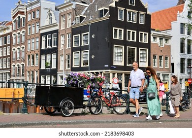 Amsterdam, The Netherlands - 18 June 2022: Everyday Life Of Tourists And Townspeople In Amsterdam, Netherlands. Typical Street View In Amsterdam, Holland.