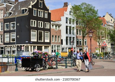 Amsterdam, The Netherlands - 18 June 2022: Everyday Life Of Tourists And Townspeople In Amsterdam, Netherlands. Typical Street View In Amsterdam, Holland.