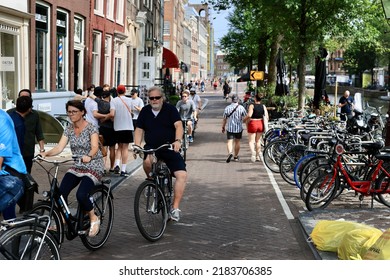 Amsterdam, The Netherlands - 18 June 2022: Everyday Life Of Tourists And Townspeople In Amsterdam, Netherlands. Typical Street View In Amsterdam, Holland.