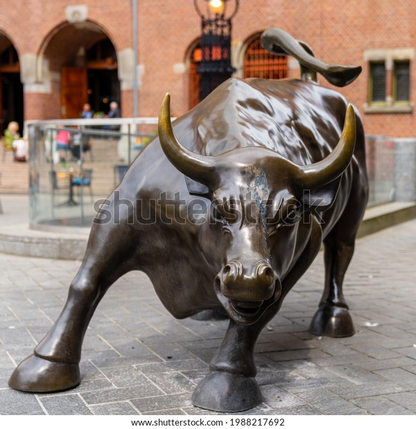 Amsterdam, Netherlands\
- 19 May, 2021: statue of the stock market bull outside of the\
stock exchange in\
Amsterdam