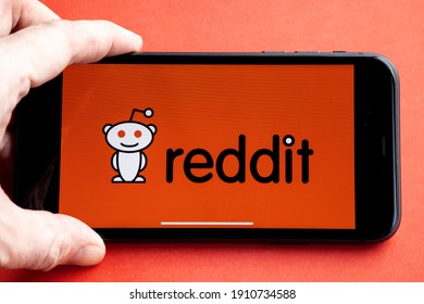 Amsterdam, Netherlands, 2021.01.28 Reddit is a social news aggregation, web content, and discussion website. Registered members submit content to the site. Reddit logo on iPhone 11