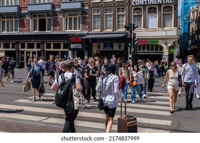 Amsterdam, The Netherlands - 21 June 2022: Many People Crossing The Street In Amsterdam