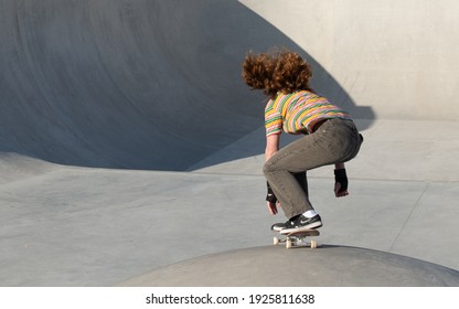 Amsterdam Netherlands 27 february 2021 Girl with curly red hair skateboarding in the skate park