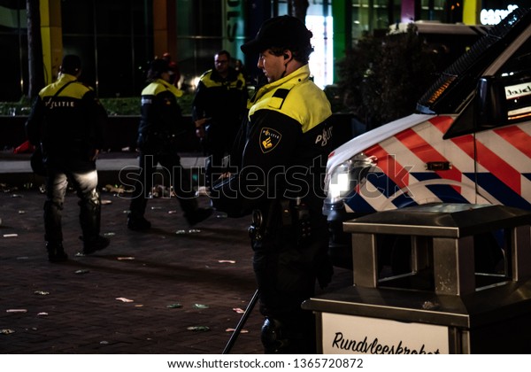 Amsterdam, The Netherlands - April 10, 2019:\
Supporters of soccer / football during Ajax - Juventus match.\
Outside during the match partying. Police force outside Arena in\
busses keeping\
peace.