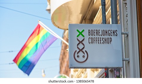 AMSTERDAM, NETHERLANDS - APRIL 20, 2019 - Boerjongens Coffeeshop Front Sign In Amsterdam With Rainbow Flag In Background