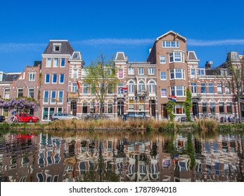 Amsterdam, The Netherlands - april 27 2020 - Rustic canal houses reflection in the water