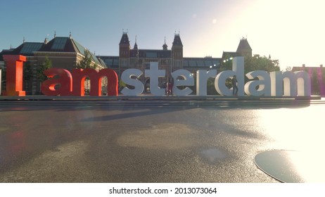 AMSTERDAM, NETHERLANDS - AUGUST 09, 2016: Popular Tourist Attraction Amsterdam Slogan In Front Of Rijksmuseum In Bright Sunlight