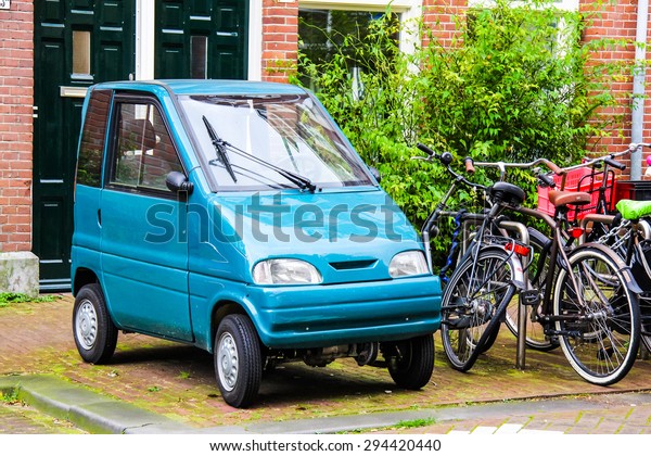 AMSTERDAM, NETHERLANDS - AUGUST 10, 2014: Tiny\
car Canta LX at the city\
street.
