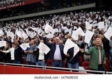 Amsterdam, Netherlands - August 13, 2019. Ajax Fans Wave Flags Before A Soccer Match Between Ajax AFC And PAOK FC.