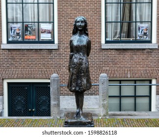 Amsterdam, Netherlands - December 21st 2019: A beautiful statue of Anne Frank in the city of Amsterdam in the Netherlands.  Anne Frank hid from Nazi persecution in hidden rooms of a house in the city.