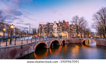 Amsterdam Netherlands during sunset, historical canals during sunset hours. Dutch historical canals in Amsterdam