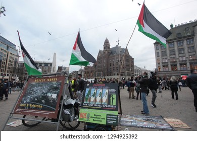 Amsterdam, the Netherlands, Europe: January 6, 2019: horizontal photo of a group protest agains Israel, with signs and flags, outdoors on a cloudy day in Dem square in front of the Palace