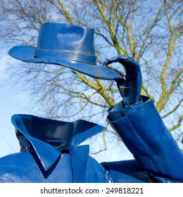 Amsterdam, The Netherlands - February 04, 2015: Detail of a sculpture placed in1982 by an anonymous artist in Amsterdam, Holland, picturing a man without head taking his hat off, on Feb. 4, 2015.
