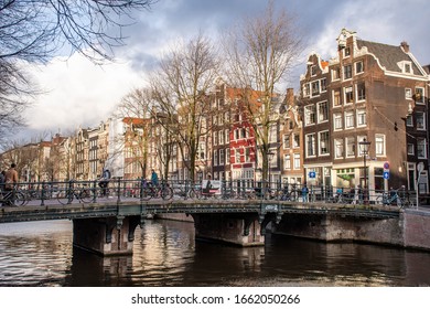 Amsterdam, Netherlands - January 29 2020: Amsterdam city center with traditional beautiful old houses, bridge and canal 