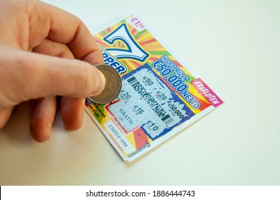 Amsterdam, Netherlands - January 2nd 2021 Scratching Lottery Ticket 7 Klapper To Check Winnings. Scratch Card With Euro Money.