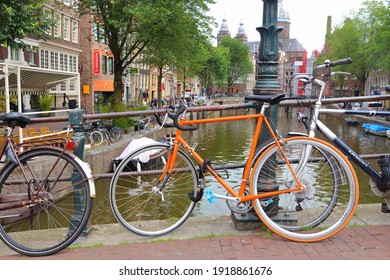 AMSTERDAM, NETHERLANDS - JULY 10, 2017: Bicycles parked at Oudezijds Voorburgwal in Amsterdam, Netherlands. Amsterdam is the capital city of The Netherlands.