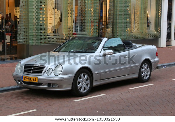 AMSTERDAM, NETHERLANDS - JULY\
10, 2017: Silver Mercedes-Benz E-class convertible car parked in\
Amsterdam. Netherlands has 528 registered cars per 1,000\
inhabitants.