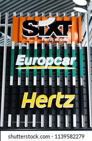 AMSTERDAM, NETHERLANDS - JULY 18, 2018: SIXT Hertz Europcar rental car billboard on steel fence.