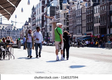 Amsterdam, The Netherlands - July 30 2018: Tourist People Walking On A Sunny Day