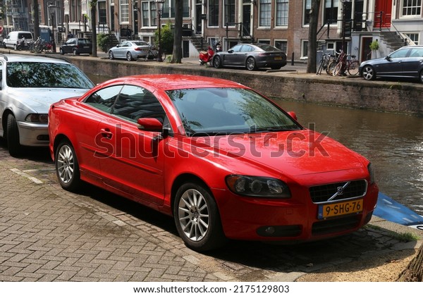 AMSTERDAM, NETHERLANDS - JULY 7, 2017: Volvo\
C70 coupe parked by the canal in Amsterdam. Netherlands has 528\
registered cars per 1,000\
inhabitants.
